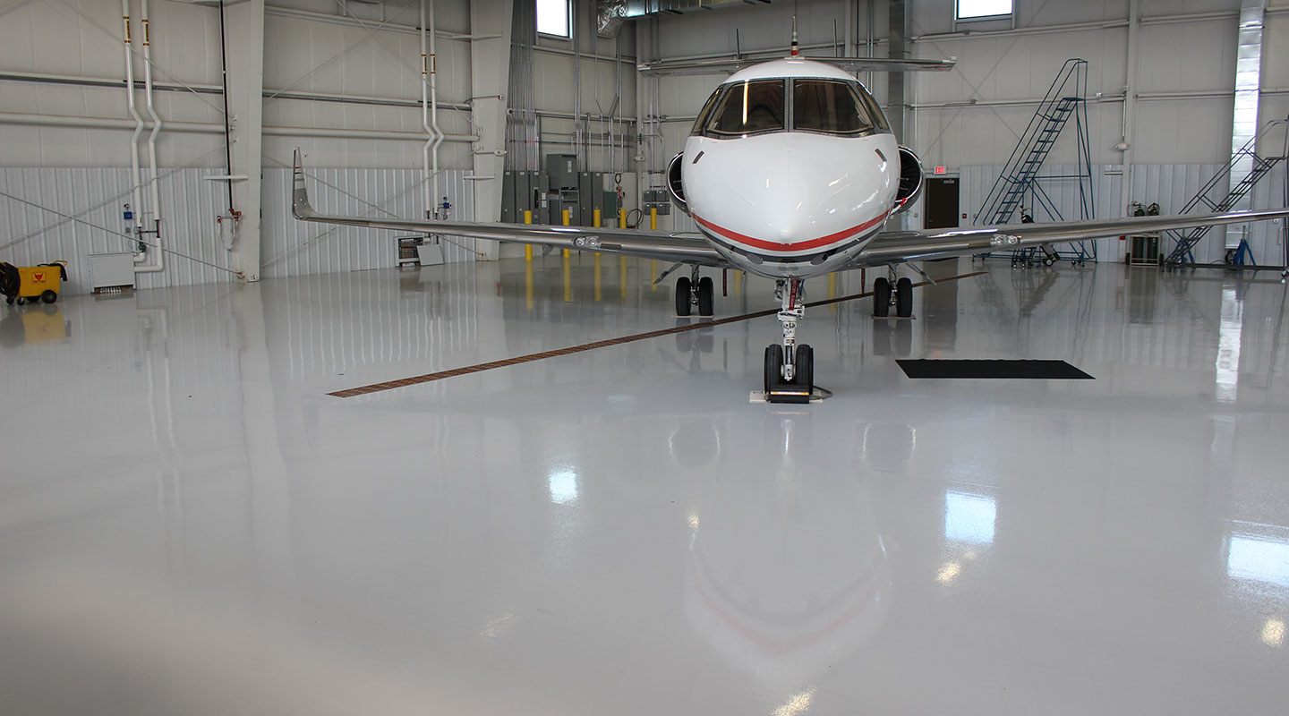 floor coating in airplane hangar with airplane